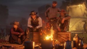 3 joueurs de Red Dead Online autour du feu de camp du campement