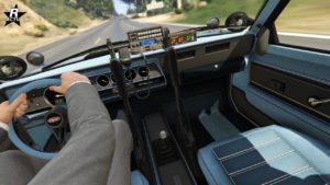 Vue de l'intérieur de la Vapid Dominator FX Interceptor. L'intérieur est typique des voitures des années 80' avec des compteurs analogique et un tableau de bord recouvert d'un tissu bleu ciel. Une radio de police se trouve sur la console principale, ainsi que deux armes de service. il est possible de voir les projecteurs de lumières qui sont rabattus sur le capot.