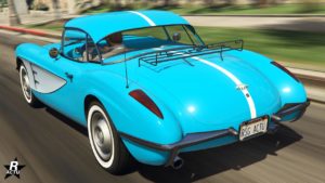 Image d'une vue arrière du véhicule Invetero Coquette D1 dans le jeu vidéo GTA Online. La carrosserie est peinte en bleu et un porte baguages se trouve sur le coffre.