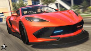 Image de l'avant de voiture de police de type supercar Invetero Coquette D10 de poursuite dans le jeu cidéo GTA Online. Elle est entièrement peinte en rouge vif, elle a des gyrophares dans son pare-chocs avant et dans la partie supérieure du pare-brise.