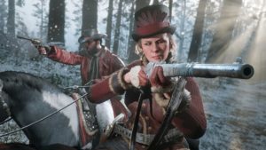 Image de deux personnages de Red Dead Online portant les gants à fourrure rouges et chapeaux rouges qui sont à débloquer en relevant les objectifs des avantages de la semaine de décembre et de Noël.