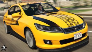 Image présentant une vue avant de la voiture Dinka Chavos V6 dans le jeu vidéo GTA Online. Le véhicule dispose d'une peinture jaune, ainsi qu'un motif hexagonal qui recouvre le centre de son capot, ainsi que sur ses côtés latéraux.