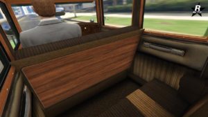 Image donnant un aperçu sur la banquette arrière dans l'habitacle de la voiture des années 1920 Albany Roosevelt Valor dans GTA Online. De la boiserie et des tissus beiges recouvre l'intérieur.