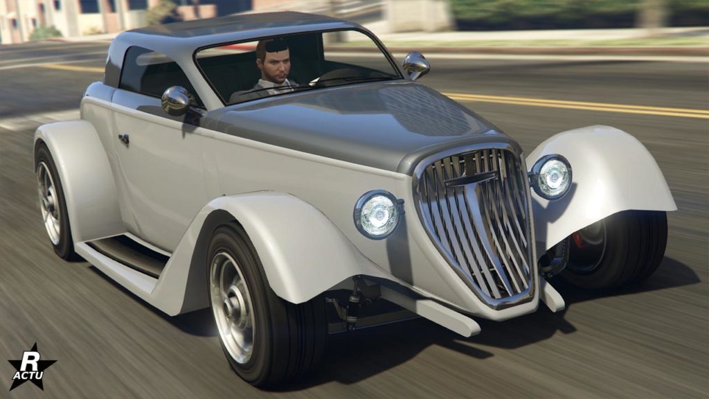 Image présentant le véhicule Vapid Hotknife de l'avant dans le jeu vidéo GTA Online. Les côtés latéraux sont peints en gris clair, tandis que le capot et le toit sont de couleur gris foncé.
