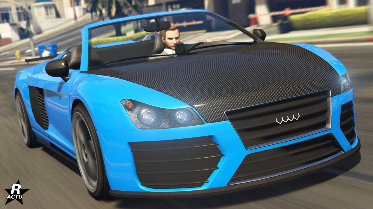 L'avant de la sportive Obey 9F Cabrio dans le jeu vidéo GTA Online de Rockstar Games. La voiture est présentée avec une couleur bleu fluo et un capot noir en carbone. Elle est en mode décapotable, où le toit en toile se trouve repliée dans le coffre.