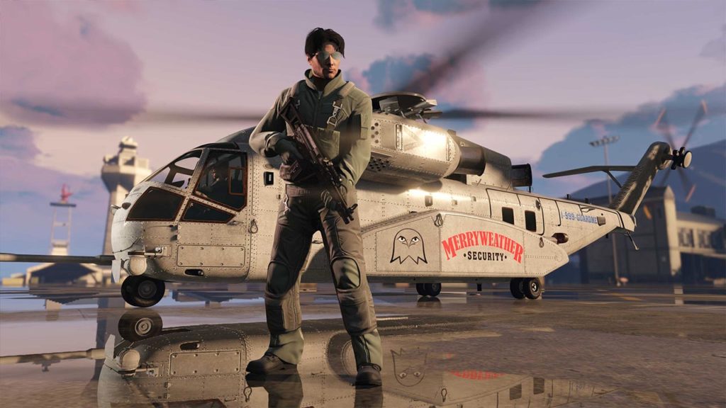 L'hélicoptère Buckingham DH-7 Iron Mule disposant sur sa carlingue le motif exclusif Merryweather Security. L'appareil aérien se trouve posé dans la base militaire de Fort Zancudo avec un personnage jouable de GTA Online en premier plan avec une combinaison d'aviateur.