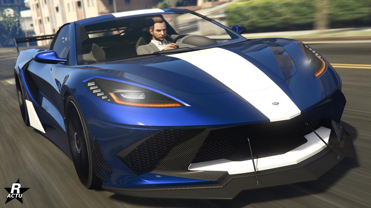 Vue avant du véhicule américain Invetero Coquette D10 dans le jeu vidéo GTA Online de Rockstar Games. Il s'agit d'une voiture de sport moderne peinte en bleu avec une bande blanche sur le capot et le toit, ainsi qu'un splitter blanc dans la calandre.