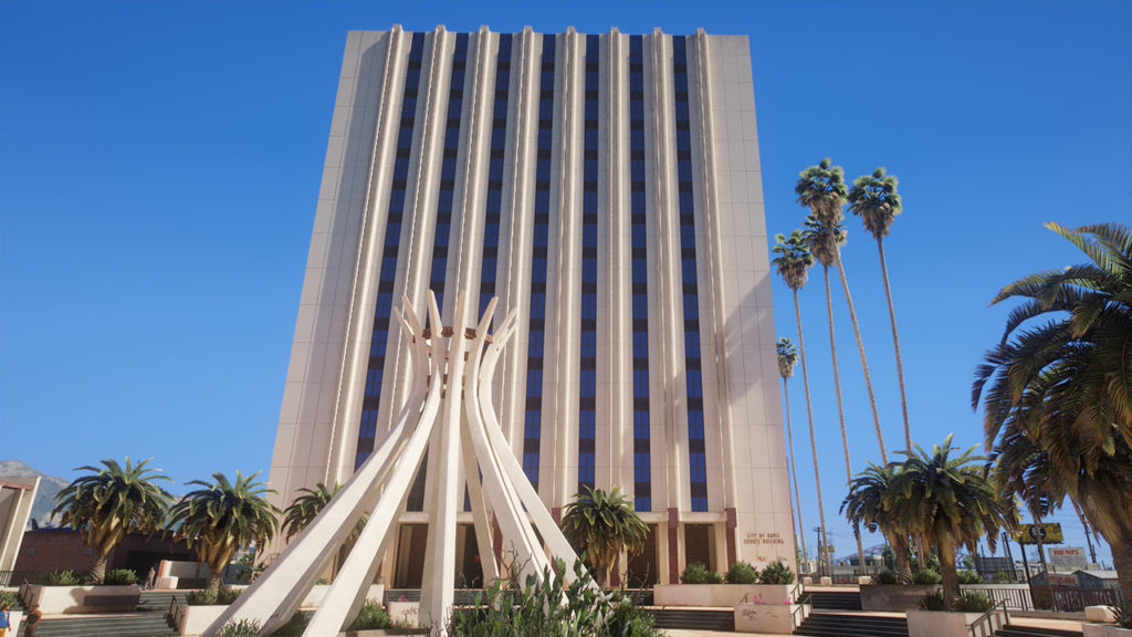 Tour de bureaux et une statue en premier plan. Le bâtiment se trouve sous un ciel bleu et le soleil illumine la façade avec un dégradé de luminosité.