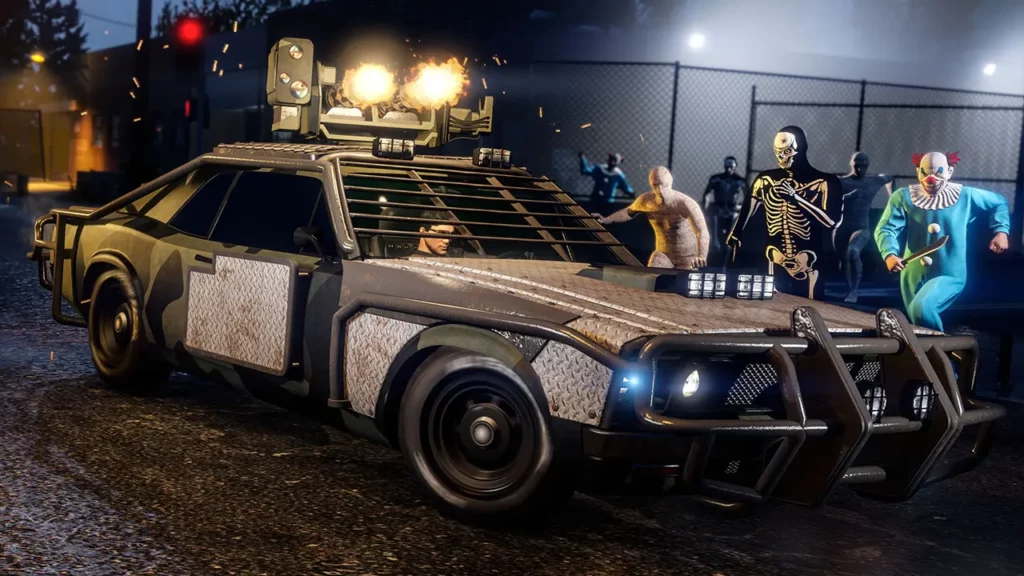 Vue avant de la voiture Declasse Tampa armée à l'arrêt en pleine nuit dans une rue du jeu GTA Online. La carrosserie est peinte en noire et grise, tout en étant recouverte à certains endroits par des tôles métalliques, lui donnant un effet de rouille. Le minigun présent sur le toit est activé et crache des flammes. Des joueurs en tenues d'Halloween (clown, squelette et momie) avancent en direction du bolide.