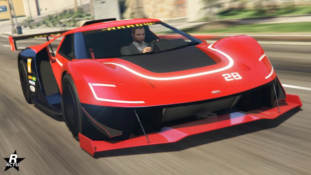L'avant du véhicule Vapid FMJ MK V sur une route de GTA Online, la super car est de couleur rouge avec une bande blanche entourant la partie centrale en carbone du capot.