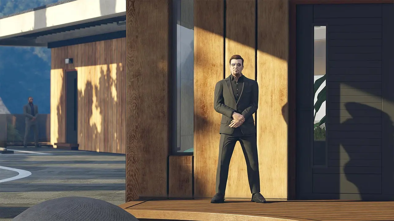 Garde du corps en costume noir devant la porte d'entrée d'un manoir de GTA Online.