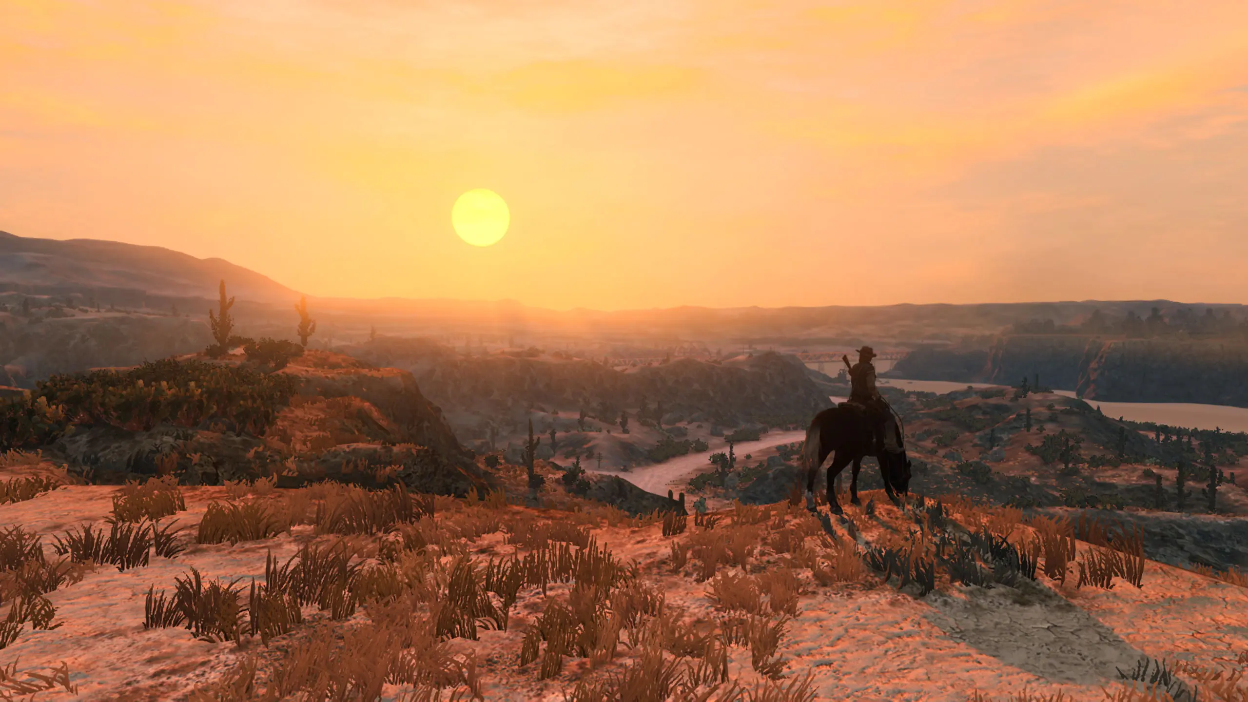 John marston sur son cheval, avec une vue sur les plaines d'une zone désertique donnant sur un couché de soleil. Image capturée sur Nintendo Switch 2.