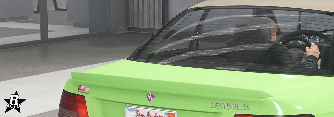 Petit aileron aérodynamique en forme de bec de canard peint dans la couleur principale du véhicule, à l'extrémité du coffre arrière.