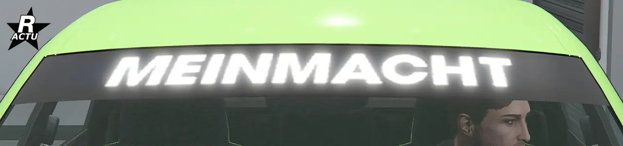 Vue rapprochée du pare-brise avant où le pare-soleil noir avec l'inscription "Meinmacht" est présent.