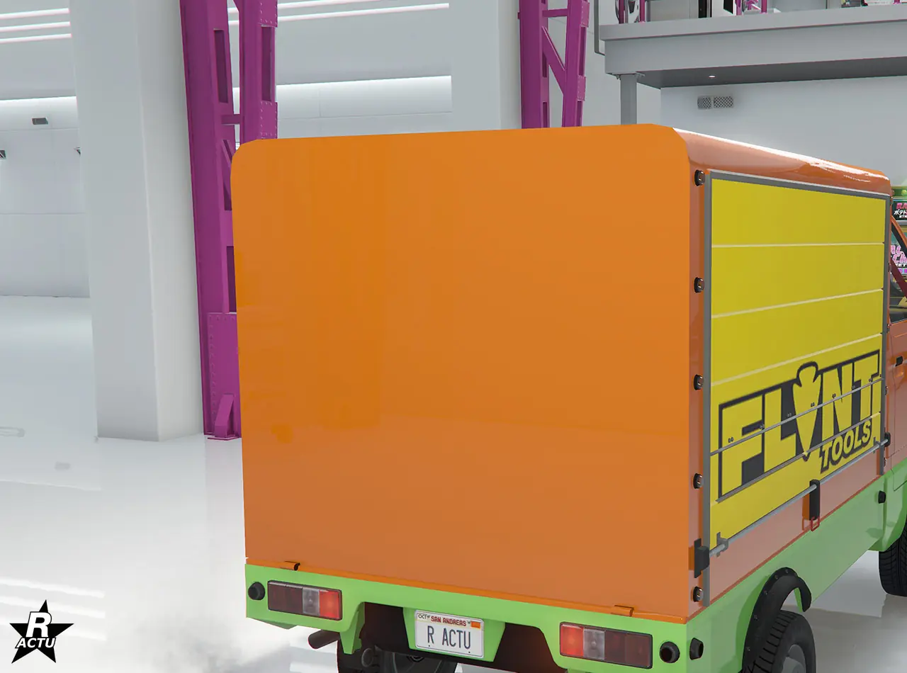 Option de personnalisation, remplaçant le plateau arrière de la camionnette, par une benne de stockage avec volets déroulant latéraux jaune surmontés du logo de l'entreprise d'outillages « Flint ».