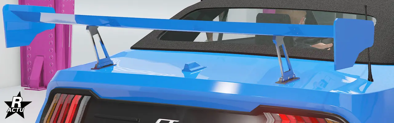 Option ajoutant un aileron de course imposant peint dans la couleur principale avec son système de fixation chromé, au-dessus du coffre de la Vapid Dominator GT.