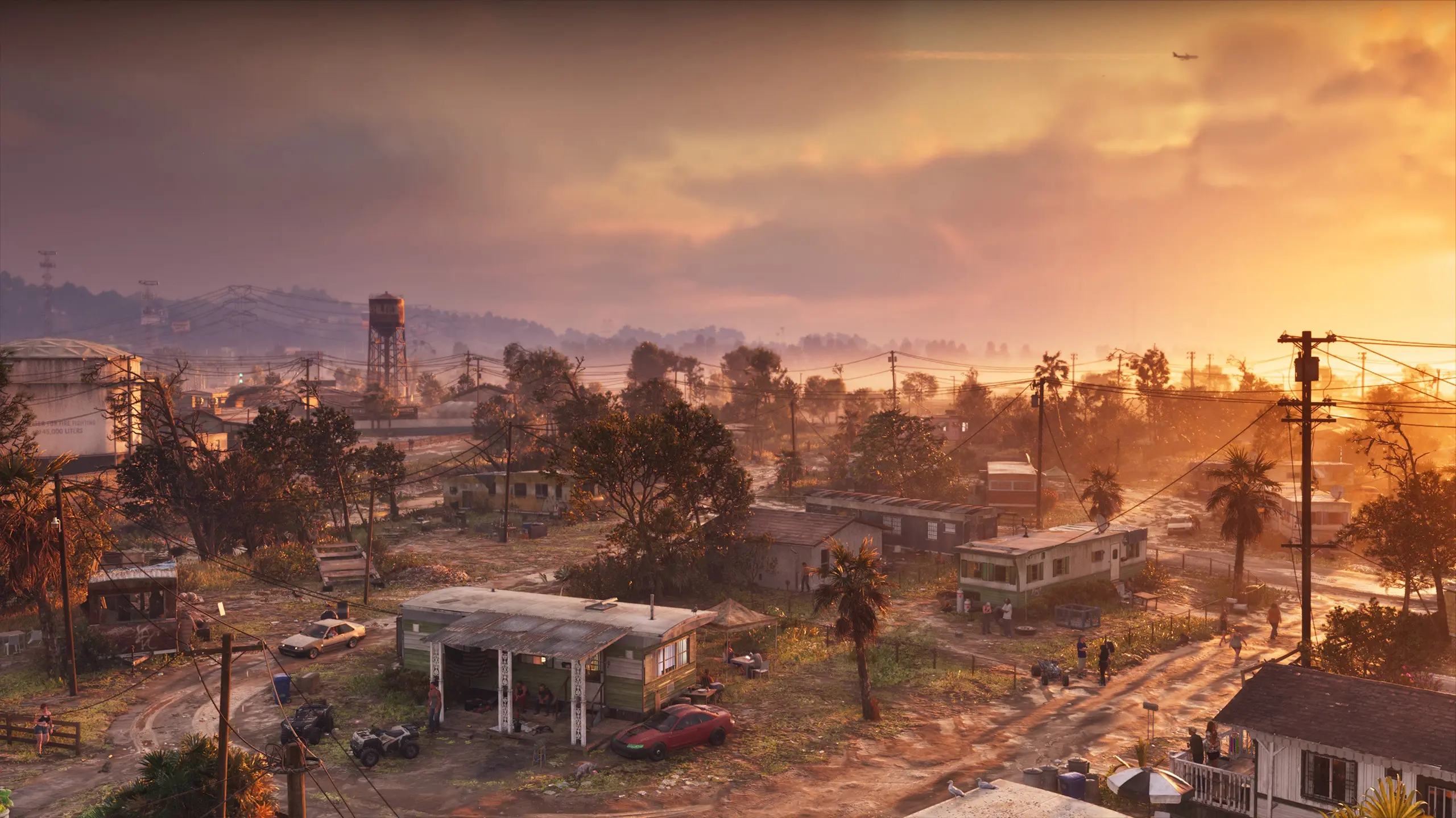 Image d'une zone reculée de la région de GTA VI, avec différentes caravanes et un couché de soleil.