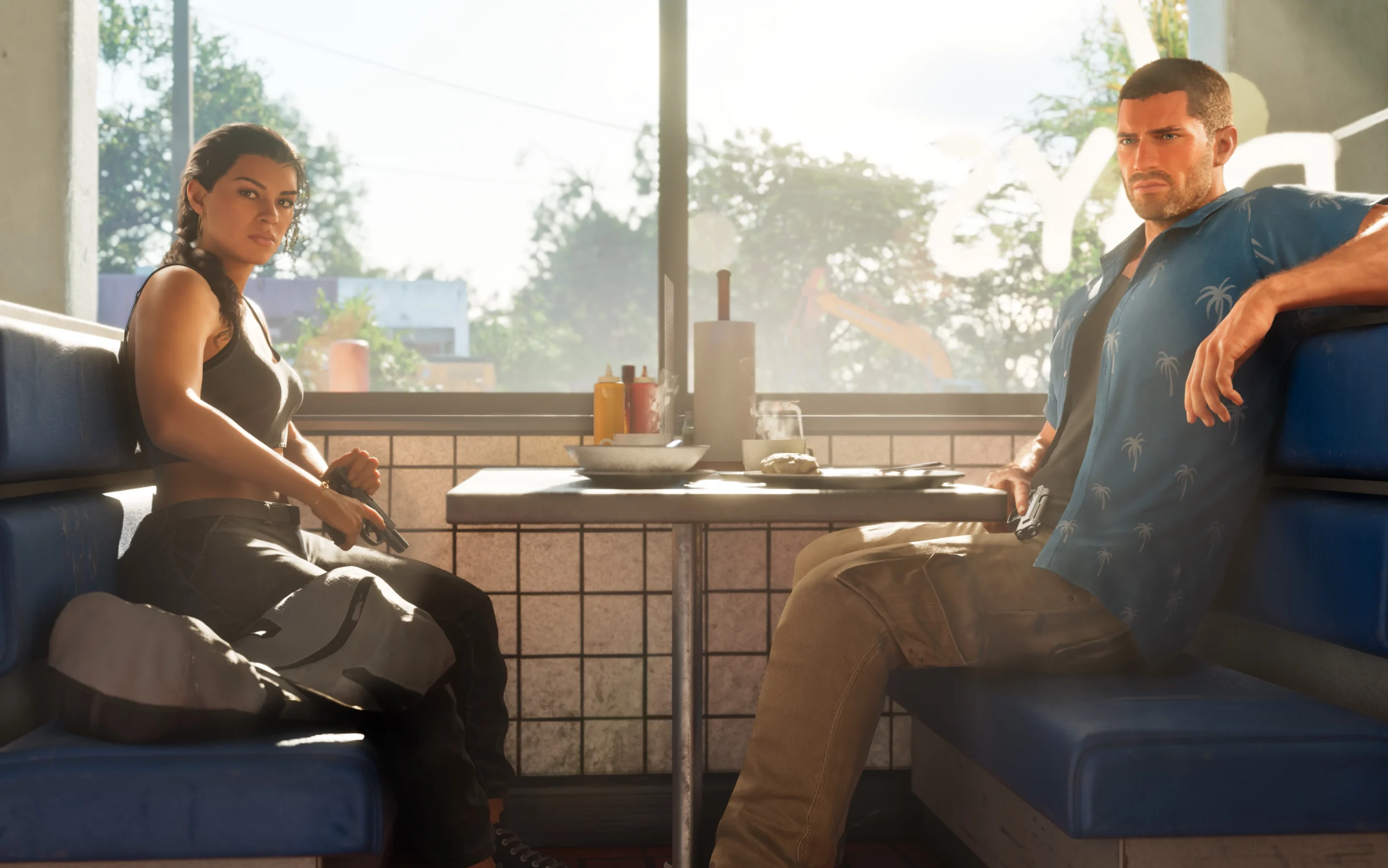 Jason et Lucia assis face à face dans un Diner, en regardant vers l'objectif de la caméra de cette image.