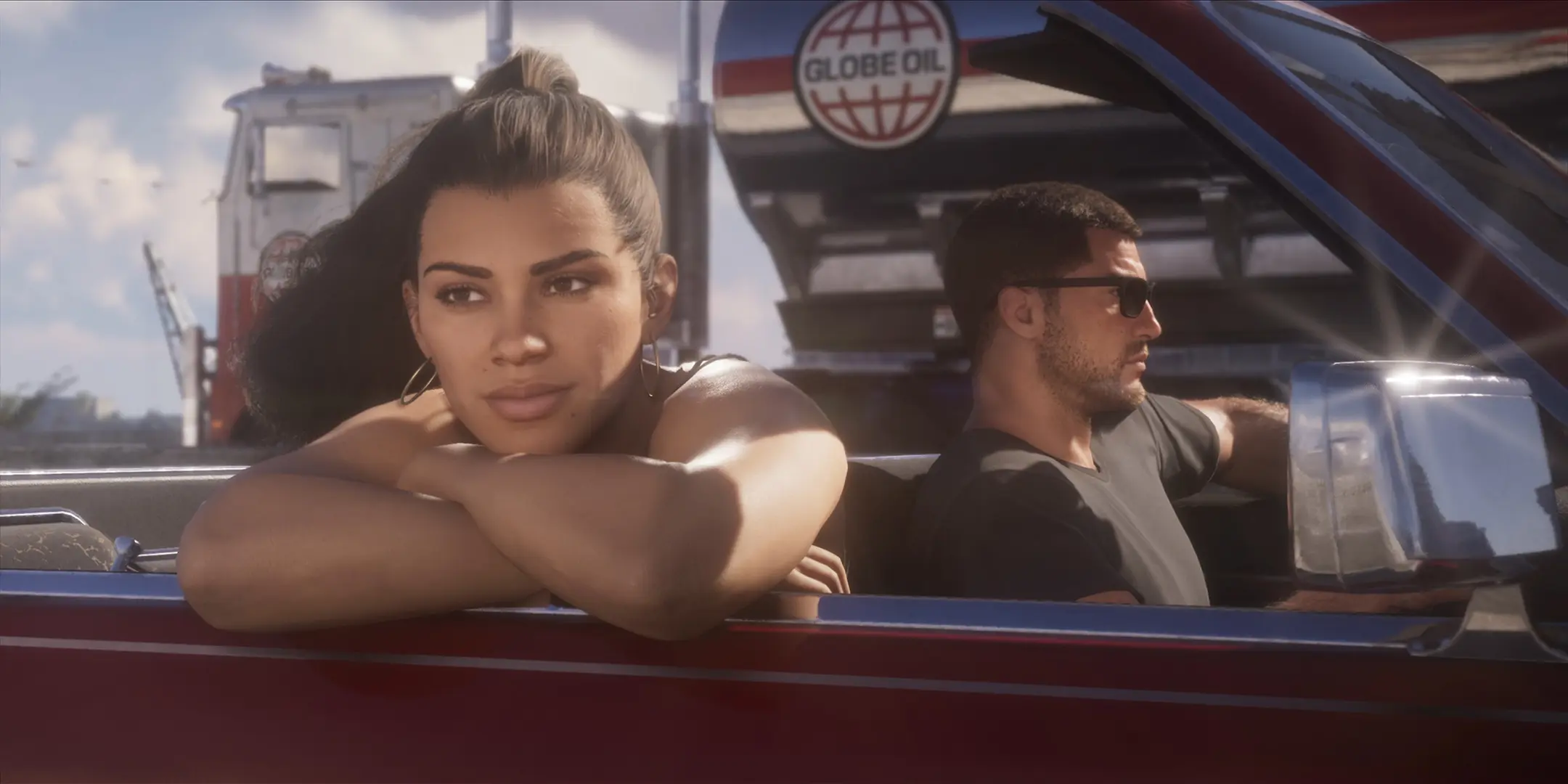 Lucia et Jason dans une voiture, Lucia est passagère et lance un regard rêveur au loin avec un camion citerne de la compagnie Globe Oil croisant le véhicule.